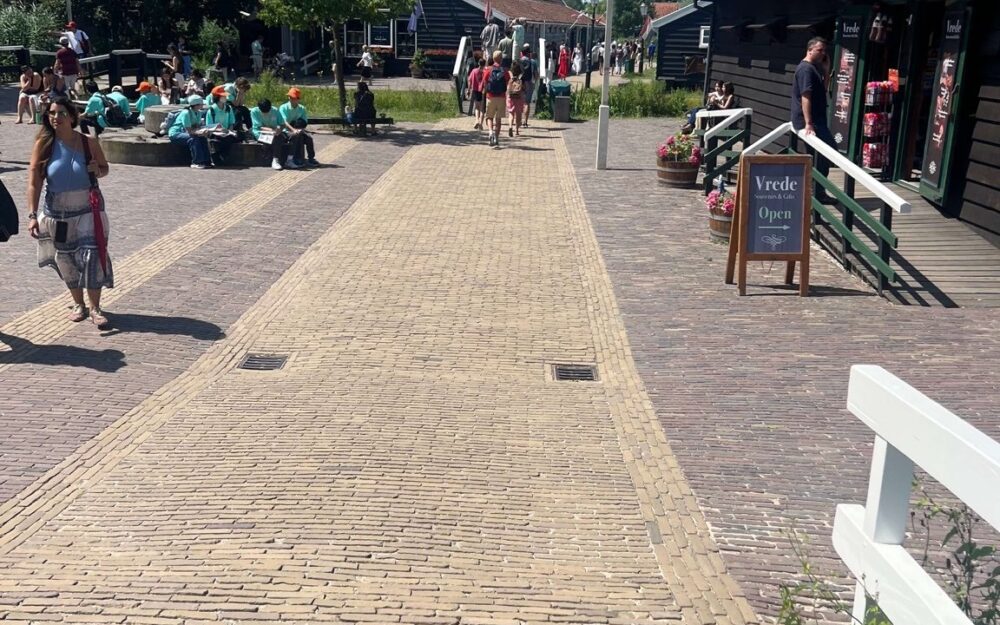Visitors walking between historic buildings in the centre of Zaanse Schans
