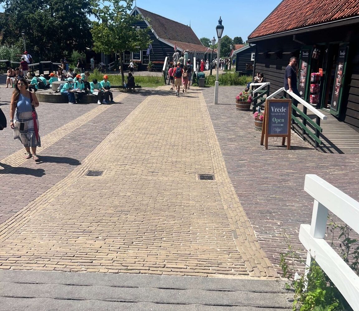 Visitors walking between historic buildings in the centre of Zaanse Schans