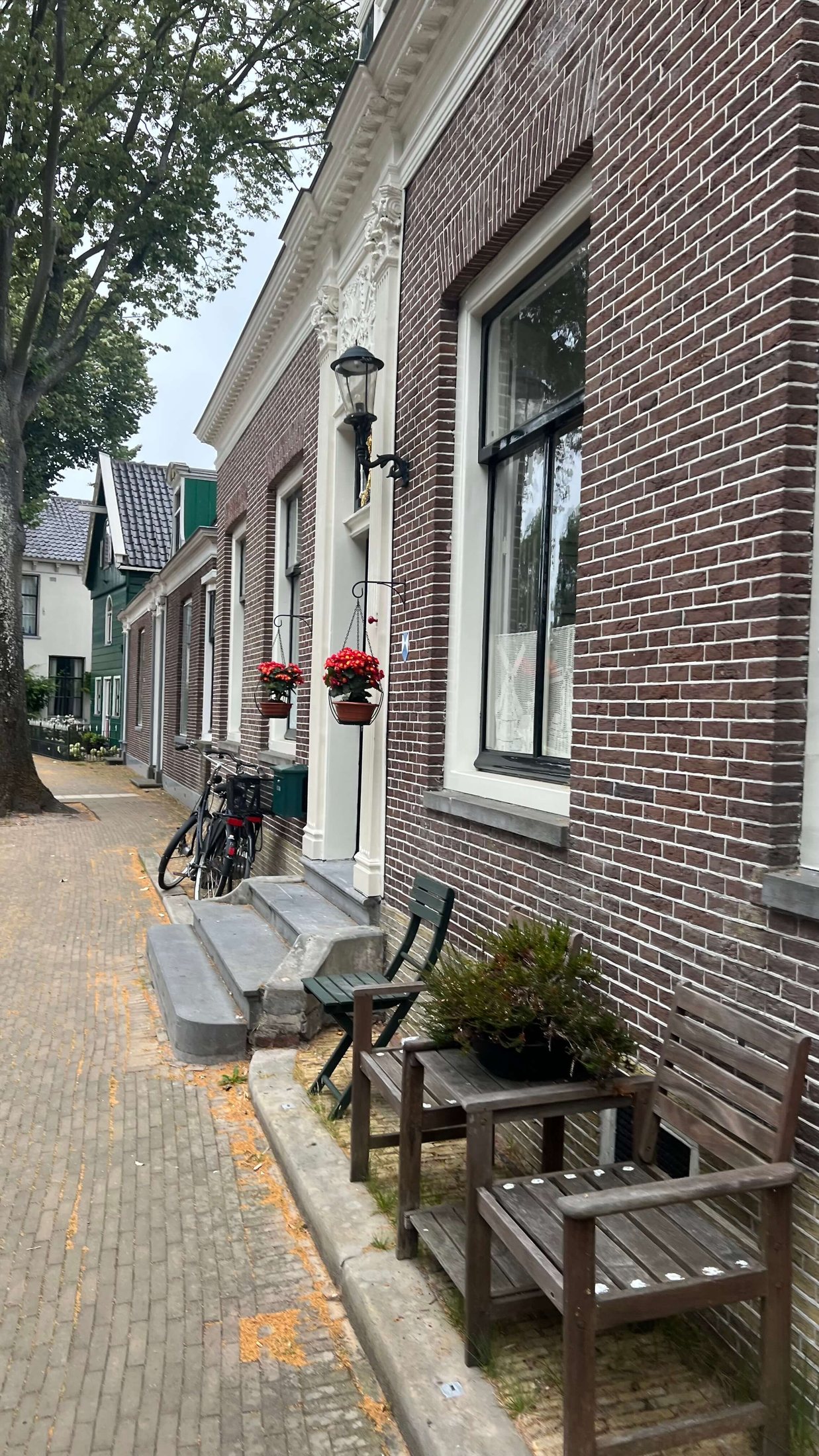 Historic Lane in Zaandijk Narrow brick lane with benches and traditional houses in Zaandijk