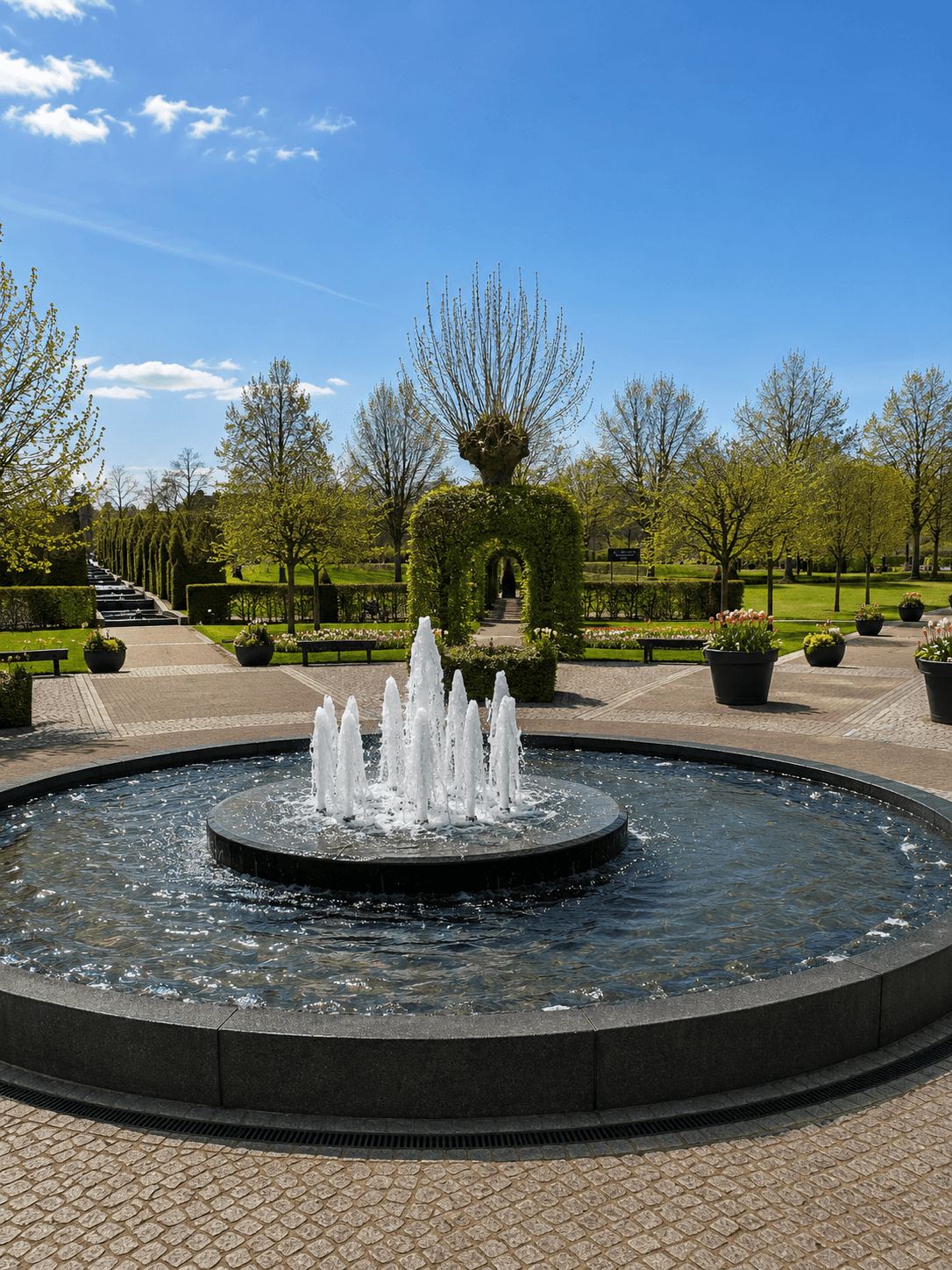 The Central Fountain at Keukenhof Circular fountain surrounded by flowerbeds and topiary at Keukenhof gardens