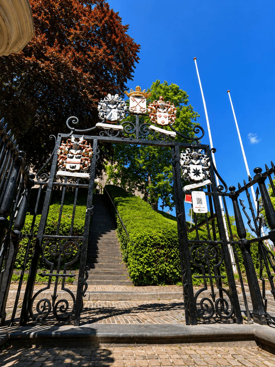 The Heraldic Gate of the Burcht van Leiden Ornate wrought-iron gate decorated with heraldic crests at the entrance to the Burcht van Leiden