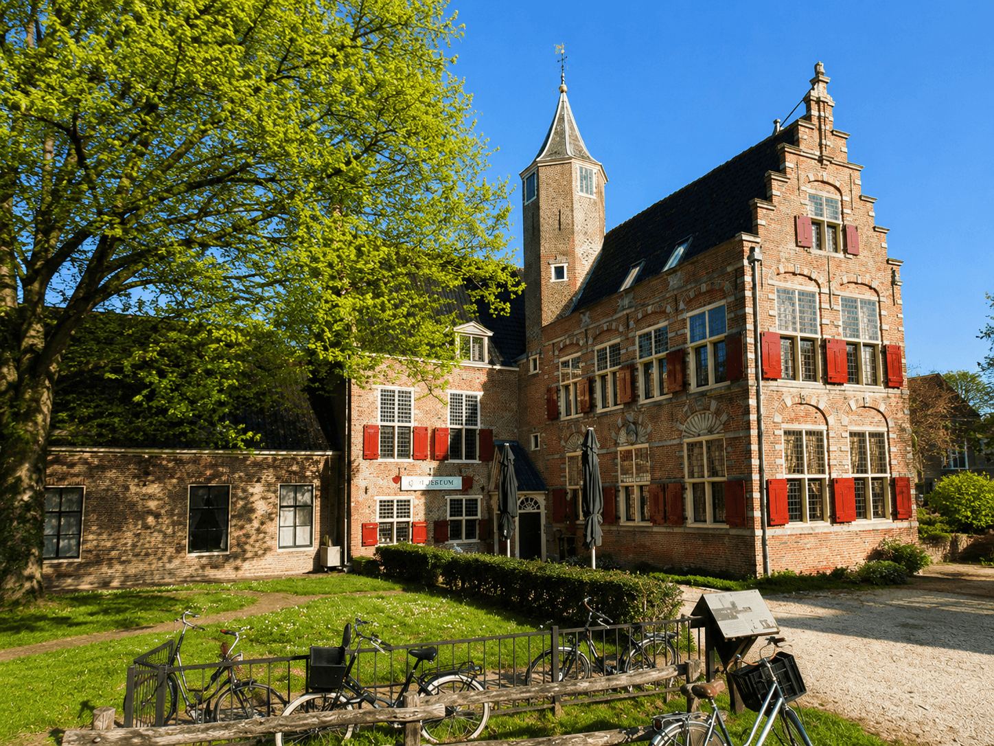 A Historic Manor House Near Leiden Historic brick manor house with red-shuttered windows and a corner tower near Leiden