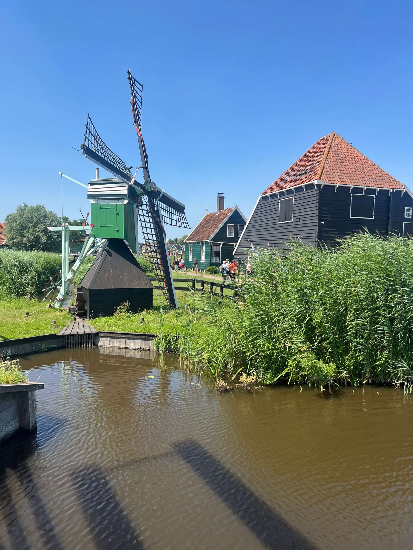 Working Windmill Beside a Zaanse Schans Canal Traditional working windmill beside a canal at Zaanse Schans