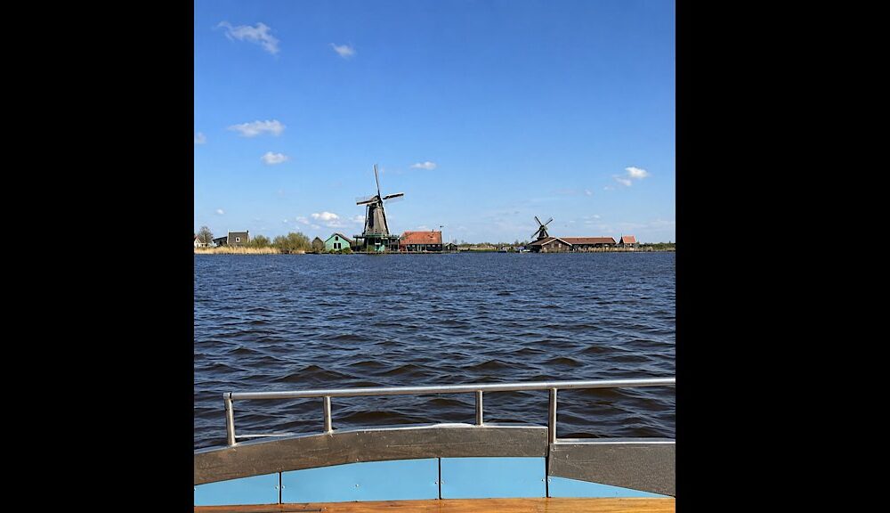 Small traditional boat moored on the Zaan river near Zaanse Schans