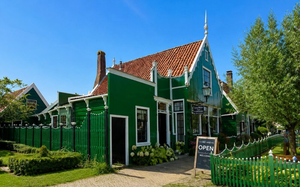Row of traditional Dutch windmills at Zaanse Schans reflected in the Zaan river