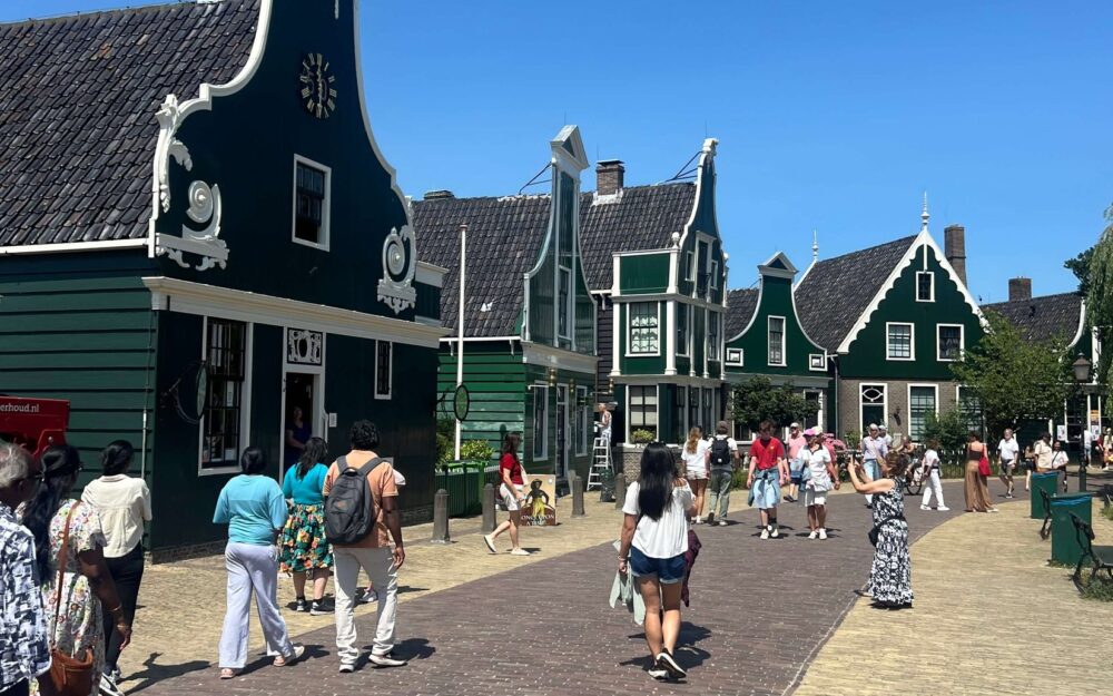 Visitors walking along the main street at Zaanse Schans on a sunny day